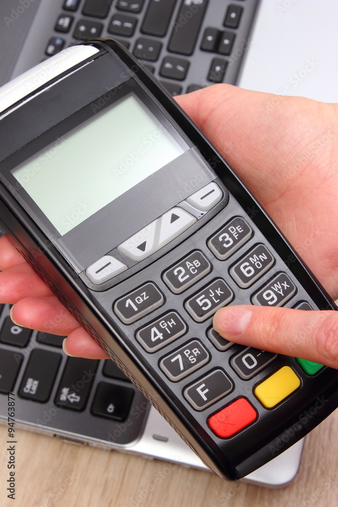 Hand of woman using payment terminal, enter personal identification number Hand of woman using payment terminal, enter personal identification number
