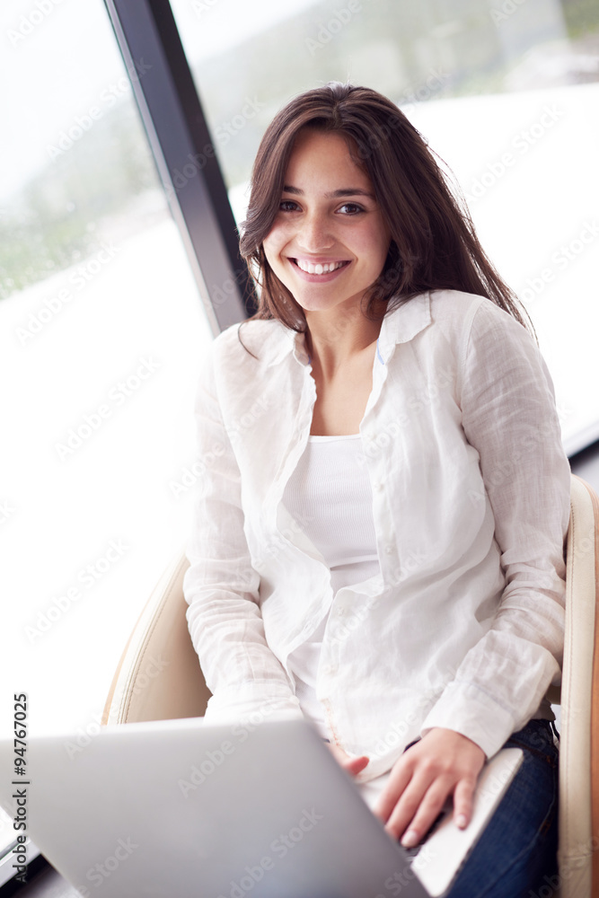relaxed young woman at home working on laptop computer relaxed young woman at home working on laptop computer
