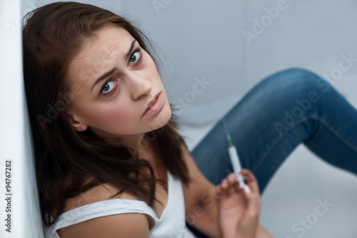 Tableau sur toile Drug addict sitting on the floor
