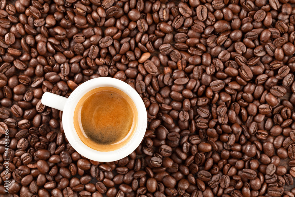 A petite espresso cup nestled amid the rich aroma of roasted coffee beans providing an evocative setting that inspires academic reflection and intellectual exploration A petite espresso cup nestled amid the rich aroma of roasted coffee beans providing an evocative setting that inspires academic reflection and intellectual exploration