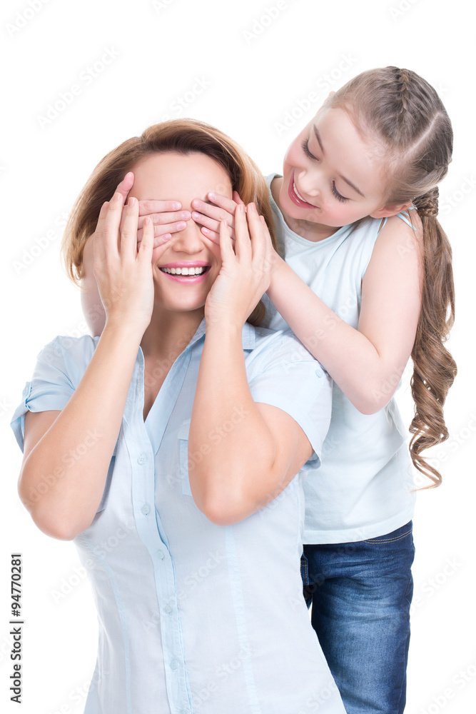 Young daughter closes hands eyes mom Young daughter closes hands eyes mom