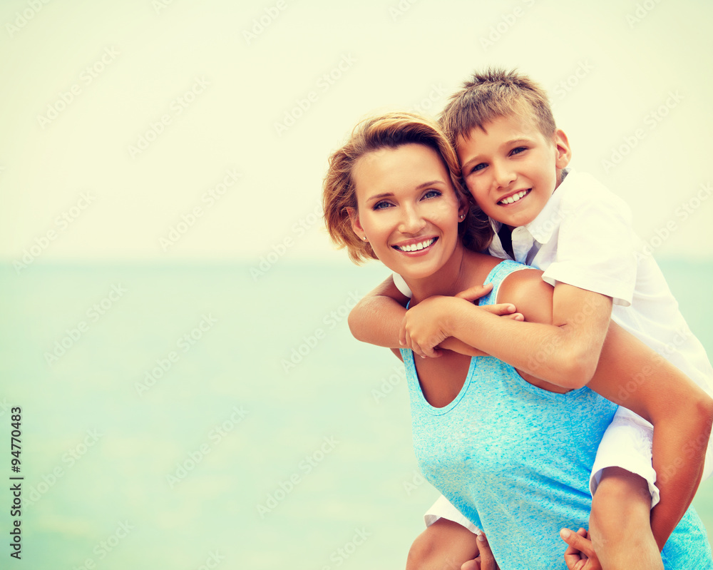 Happy mother and son having fun on the beach. Happy mother and son having fun on the beach.