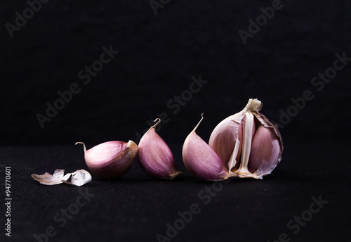  a still life arrangement of Three whole garlic bulbs grouped 
