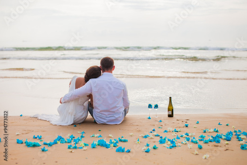 Just married couple drinking champagne at sea. selective Focus