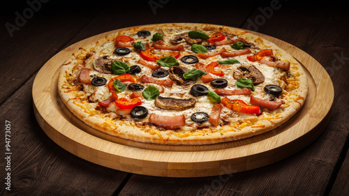 Ham pizza on wooden background