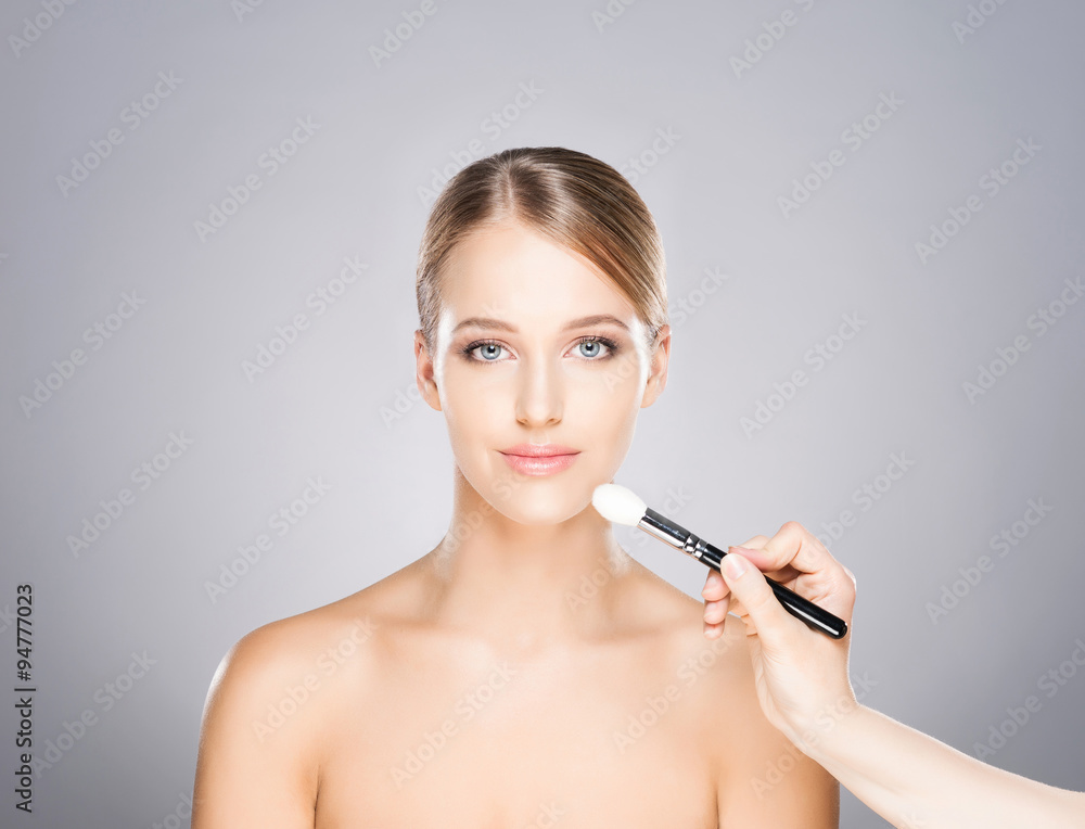 Beautiful girl is being applied with cosmetics. Beautiful girl is being applied with cosmetics.