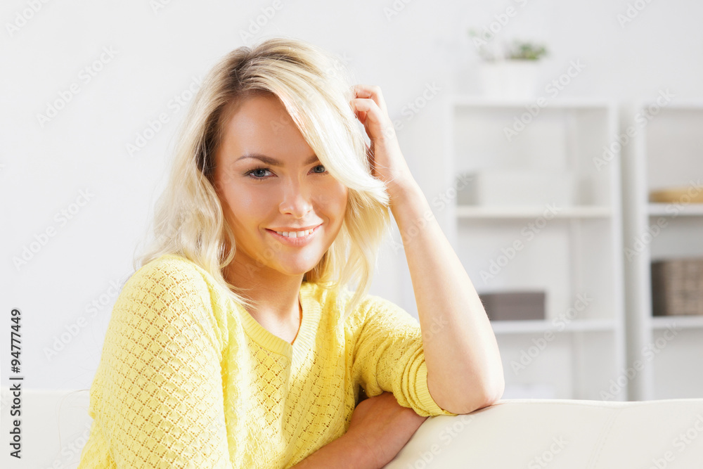 Young and happy woman resting on sofa at home Young and happy woman resting on sofa at home