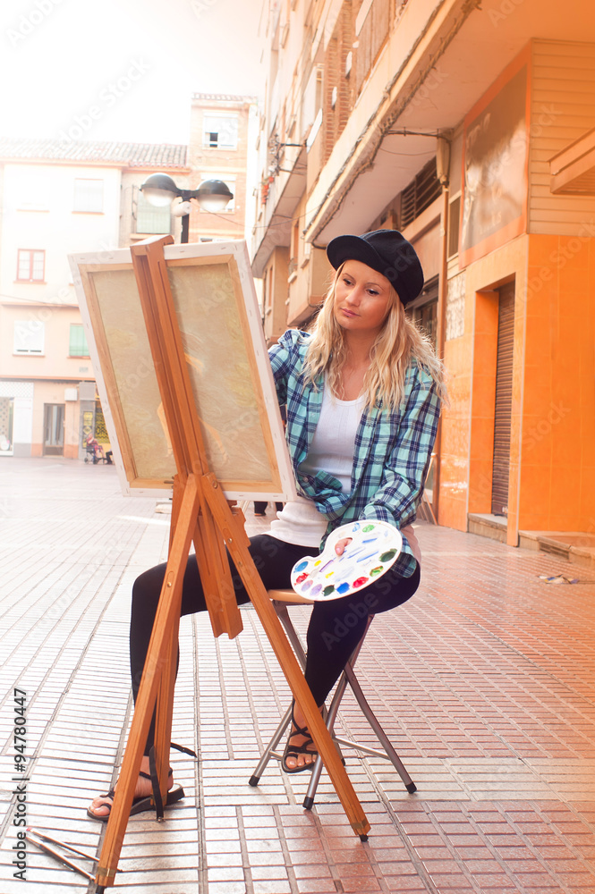 girl painting a picture on the street girl painting a picture on the street