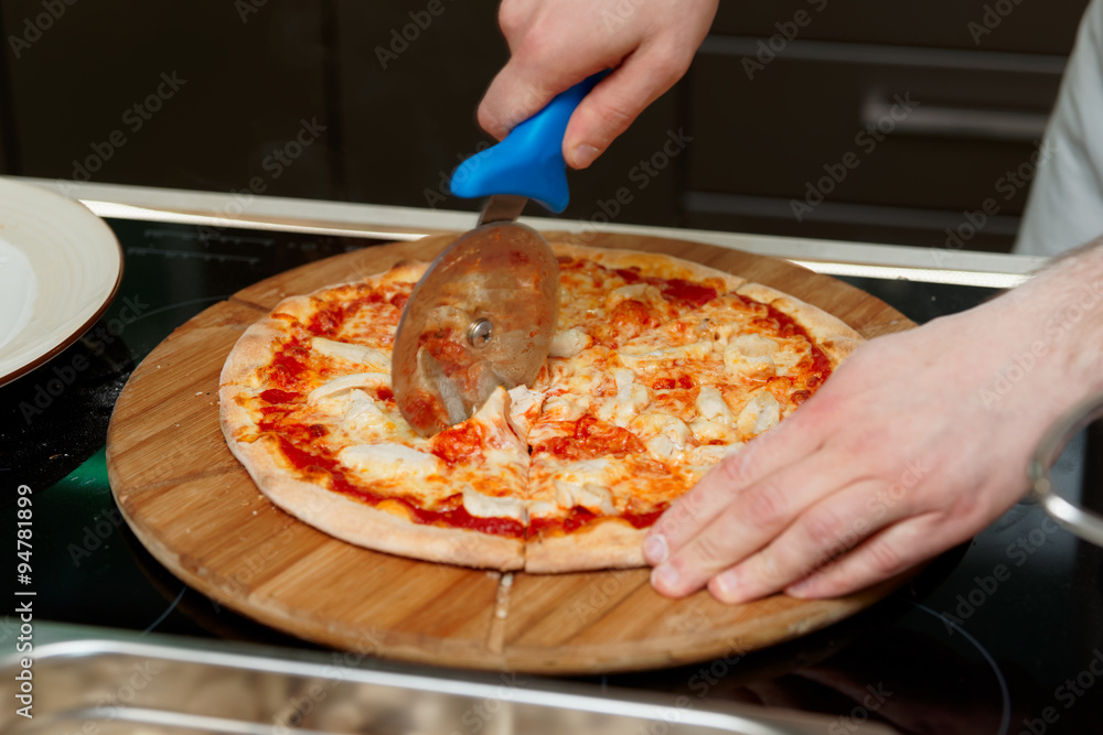 Chef is cutting pizza