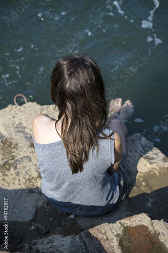 Girl put her feet in the river © magnetplus