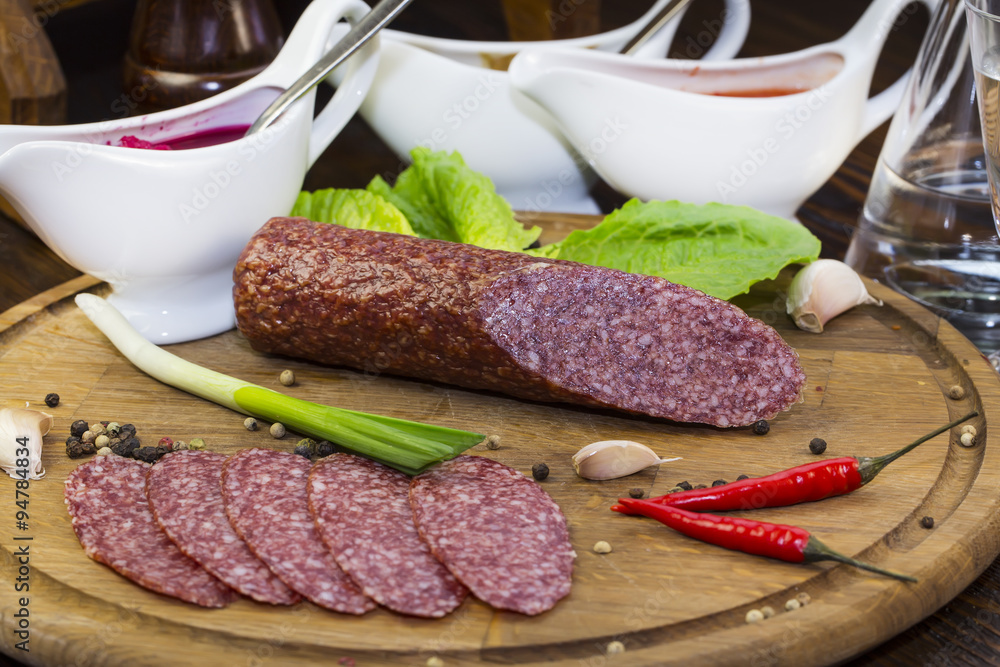 sausage on a wooden plate in a restaurant sausage on a wooden plate in a restaurant