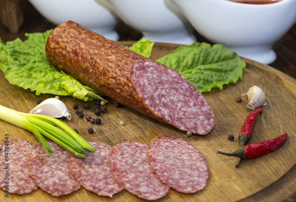 sausage on a wooden plate in a restaurant sausage on a wooden plate in a restaurant