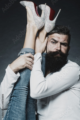 Obraz na plátně Man holding legs of woman
