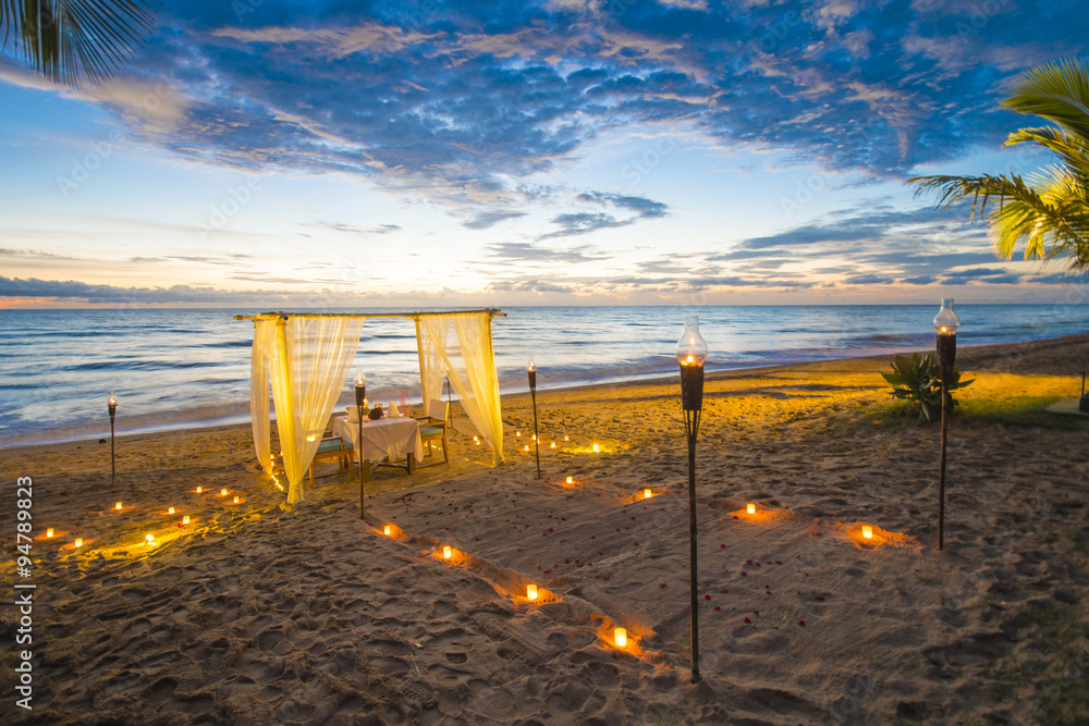 Fototapeta premium dinner set up on the beach sunset time