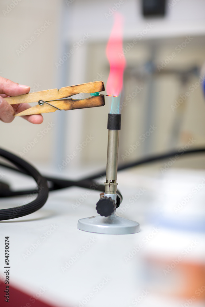 Close up of laboratory burner and tongs Close up of laboratory burner and tongs