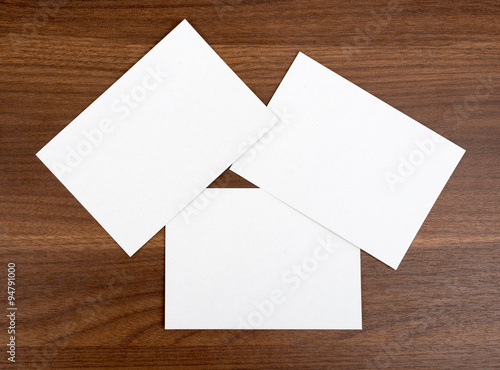 Three blank cards on wood table