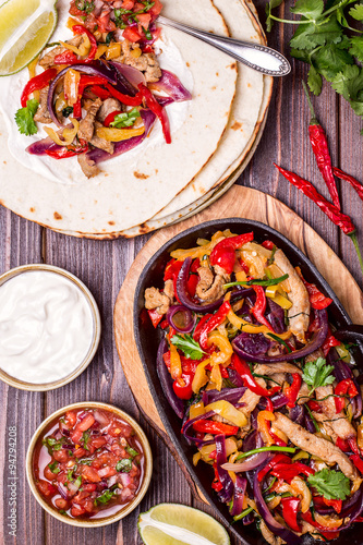 Pork fajitas with onions and colored pepper, served with tortill