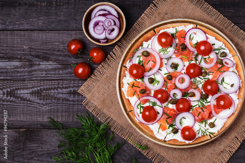 Scandinavian salmon pizza with cream cheese, capers, tomato and