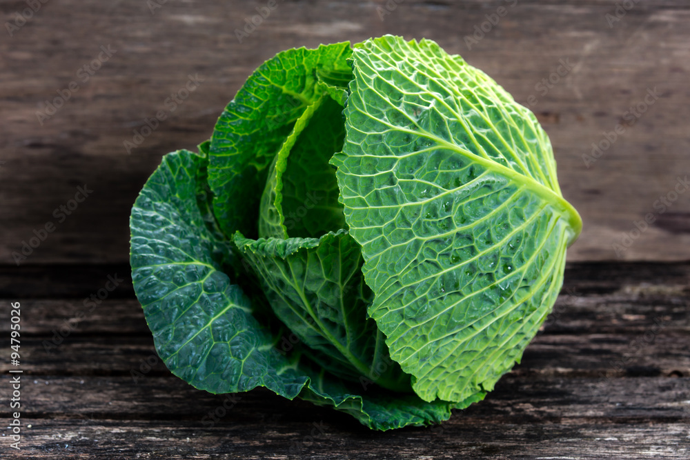 Fototapeta premium Fresh Green cabbage on old wooden table
