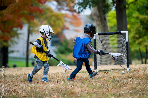 Active little kids playing lacrosse photo