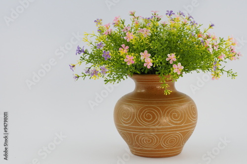 Wallpaper Mural Colorful artificial flower and green leaf in a brown vase Torontodigital.ca