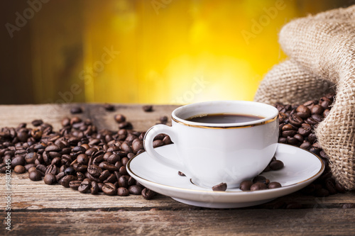 Cup of hot coffee against grunge background
