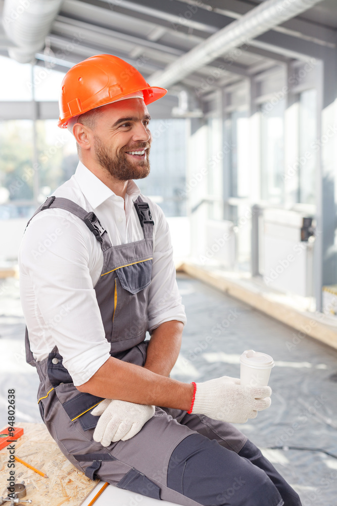Cheerful male carpenter is getting some rest Cheerful male carpenter is getting some rest