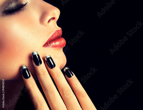 Canvas Print Beautiful model brunette shows black and silver French manicure on nails