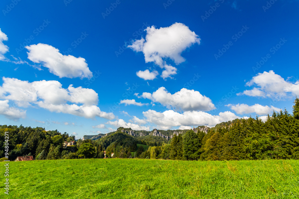 Panoramic landscape of colorful yellow-green hills, blue sky and clouds 