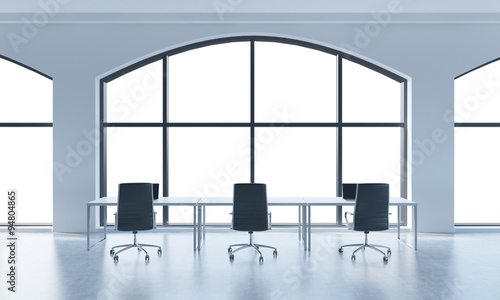 A conference room in a modern panoramic office with white copy space in windows. White table and black chairs. 3D rendering.