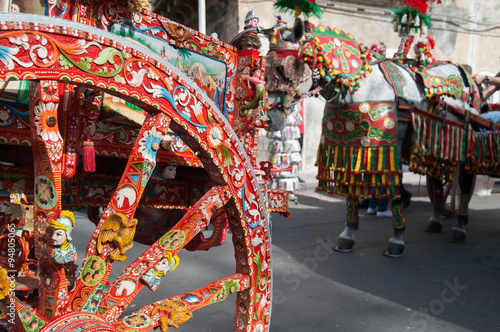 Close up view of a colorful wheel of a typical sicilian cart during a folkloristic show