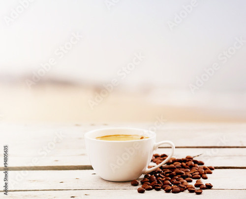 Cup of coffee on table on light background