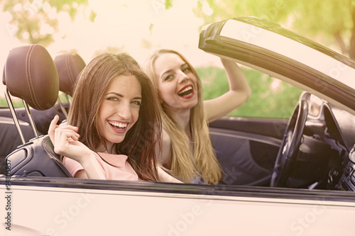 Two girls in cabriolet, out...