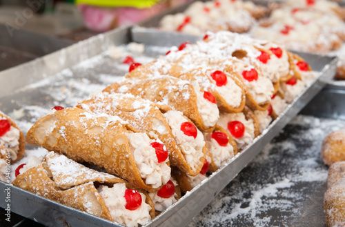 Close up of some typical sicilian cannoli for sale on a street market photo