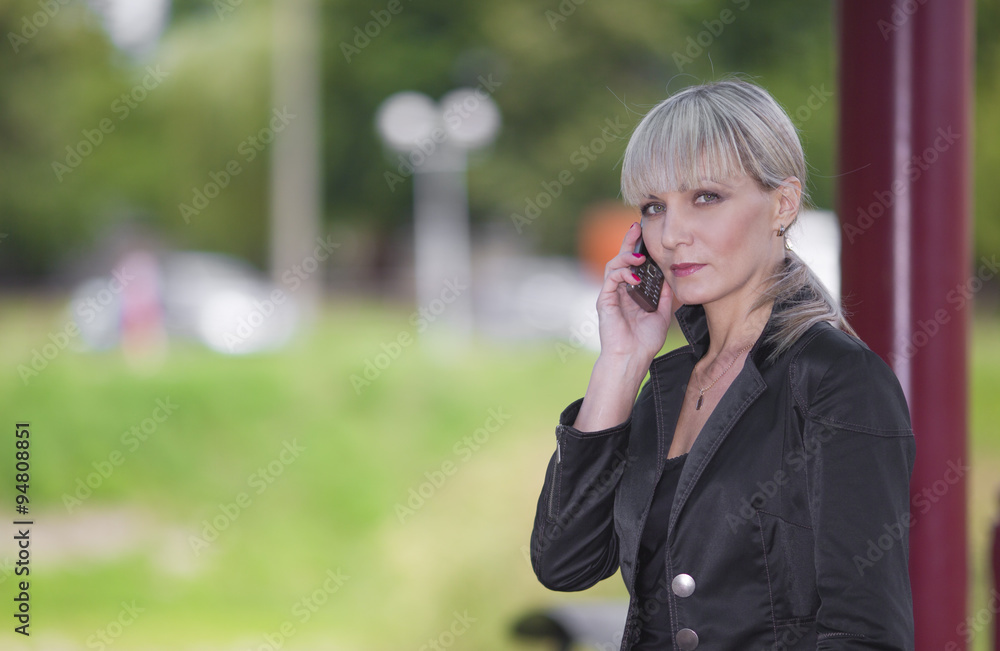 Woman speaks by phone Woman speaks by phone