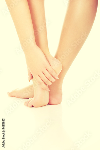 Fototapeta Naklejka Na Ścianę i Meble -  Woman touching her feet.