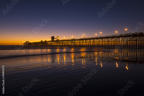 Brilliant beach sunset with pier