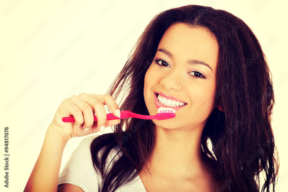 Beautiful teen brushing her teeth. Beautiful teen brushing her teeth.