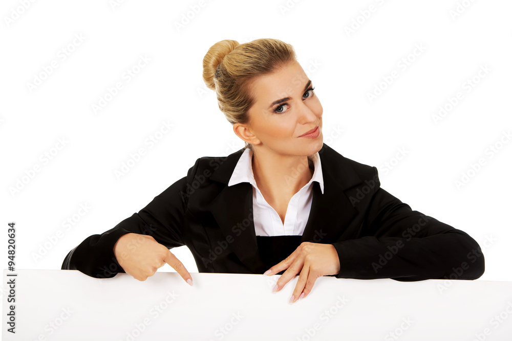 Happy businesswoman pointing on empty banner. Happy businesswoman pointing on empty banner.