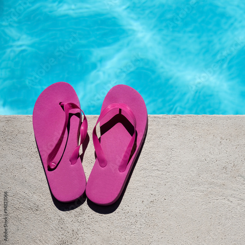 Pink slippers near swimming pool