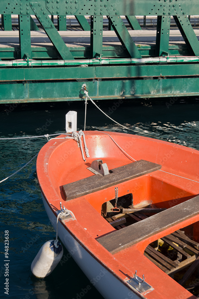 orange boat and green bridge,orange boat tied to the iron green bridge