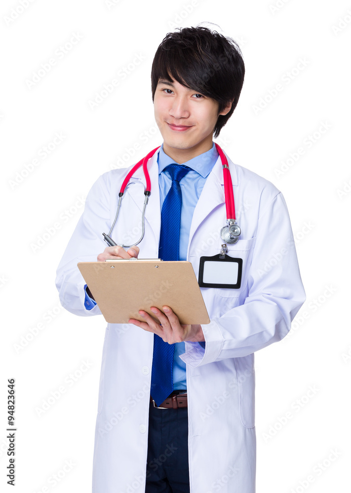 Young doctor take note on clipboard Young doctor take note on clipboard