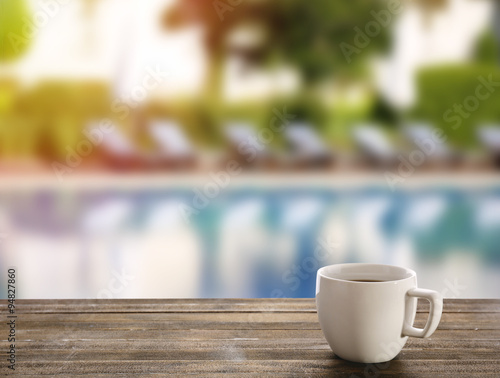 Cup of coffee on table on bright background