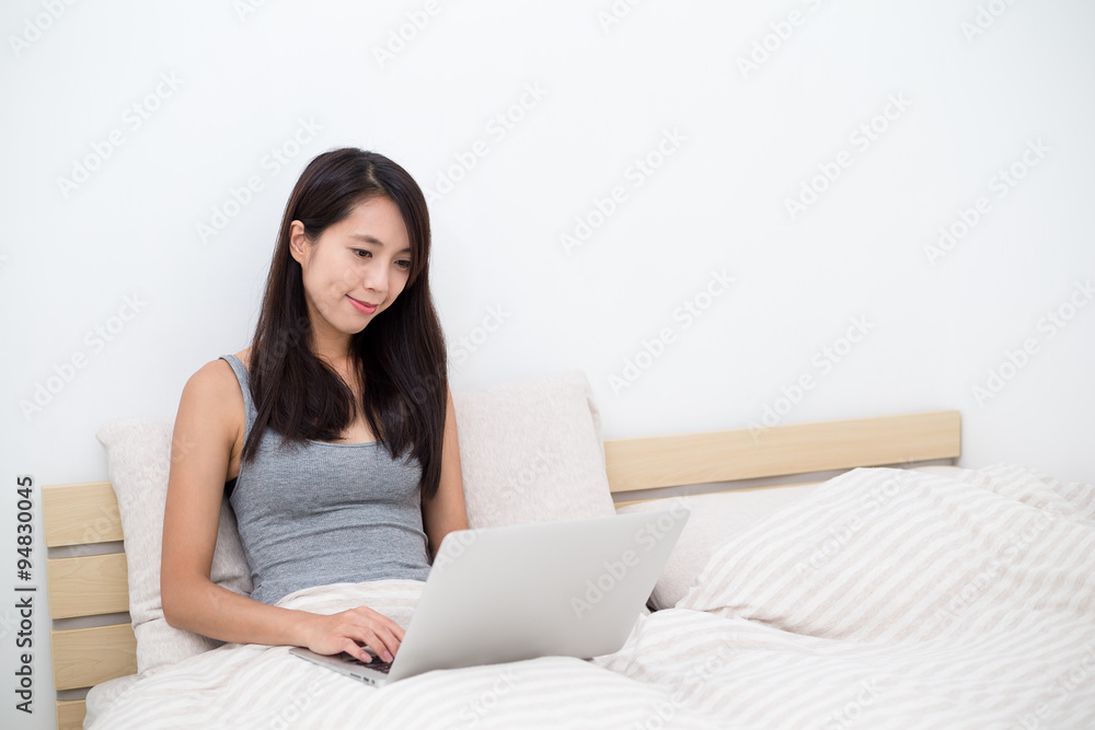 Woman using laptop computer in bed Woman using laptop computer in bed