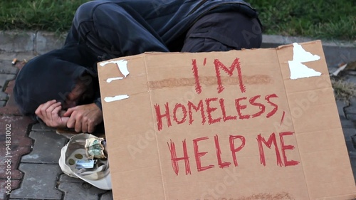 homeless man on street ,near market store 