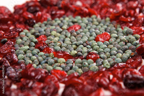Smiling face mosaic made of cranberry and green pepper