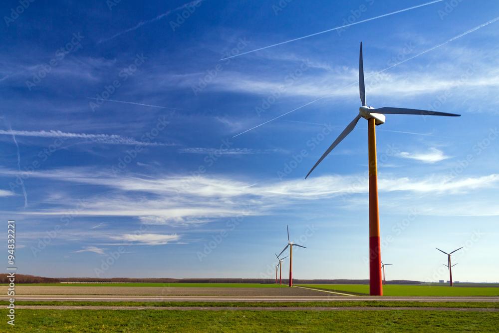 A field full of modern wind turbines for green energy in the Netherlands