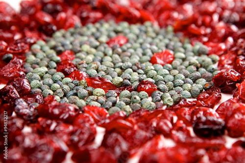 Smiling face mosaic made of cranberry and green pepper