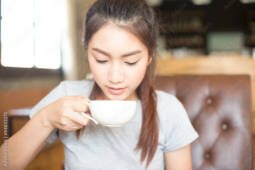 pretty young asian woman drinking coffee in room, soft and selec pretty young asian woman drinking coffee in room, soft and selec