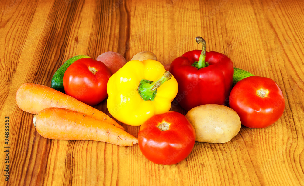 Composition with raw vegetables on wooden table Composition with raw vegetables on wooden table